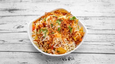 Chicken biryani with spiced basmati rice in a white bowl at Taste of Himalayan, Rowley Regis