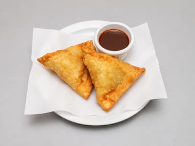 Two golden vegetable samosas with tamarind dipping sauce at Taste of Himalayan, Rowley Regis